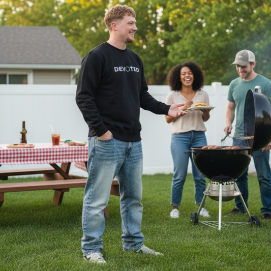 People gathered around a grill at a backyard barbecue